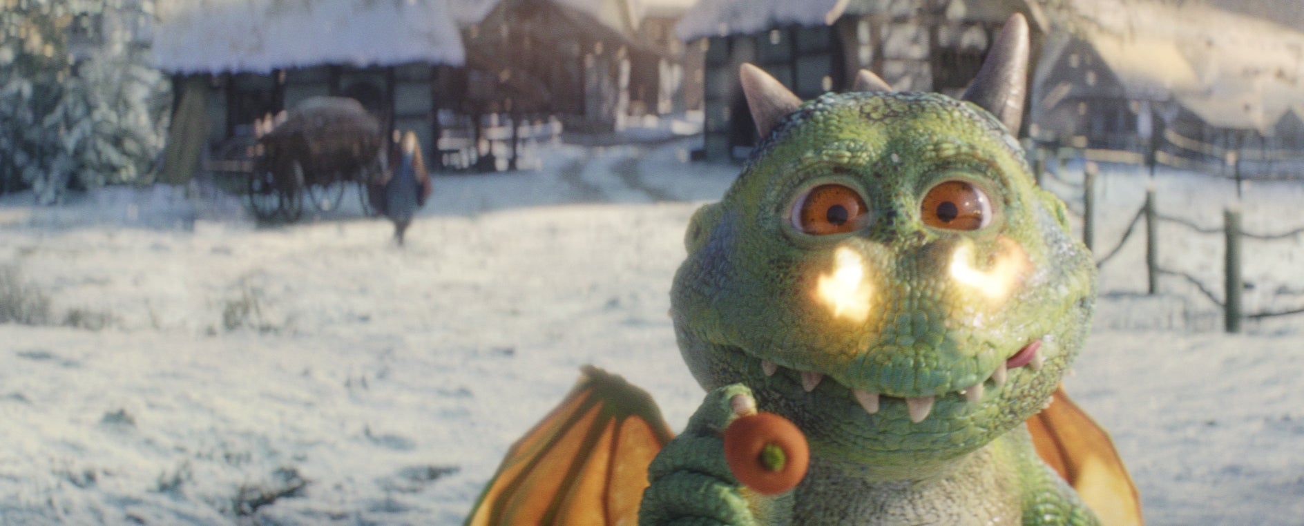 Edgar tries to place a carrot on a snowman for its nose