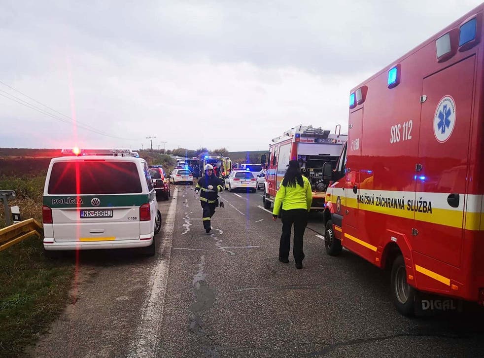 Emergency workers attend the scene after a passenger bus collided with a truck in Slovakia