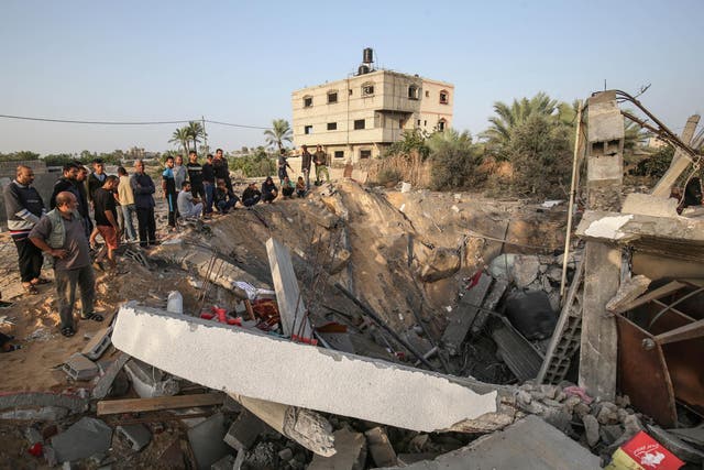 Palestinians check the remains of a house destroyed in an Israeli airstrike at Khan Yunis, in the southern Gaza Strip, on 13 November 2019