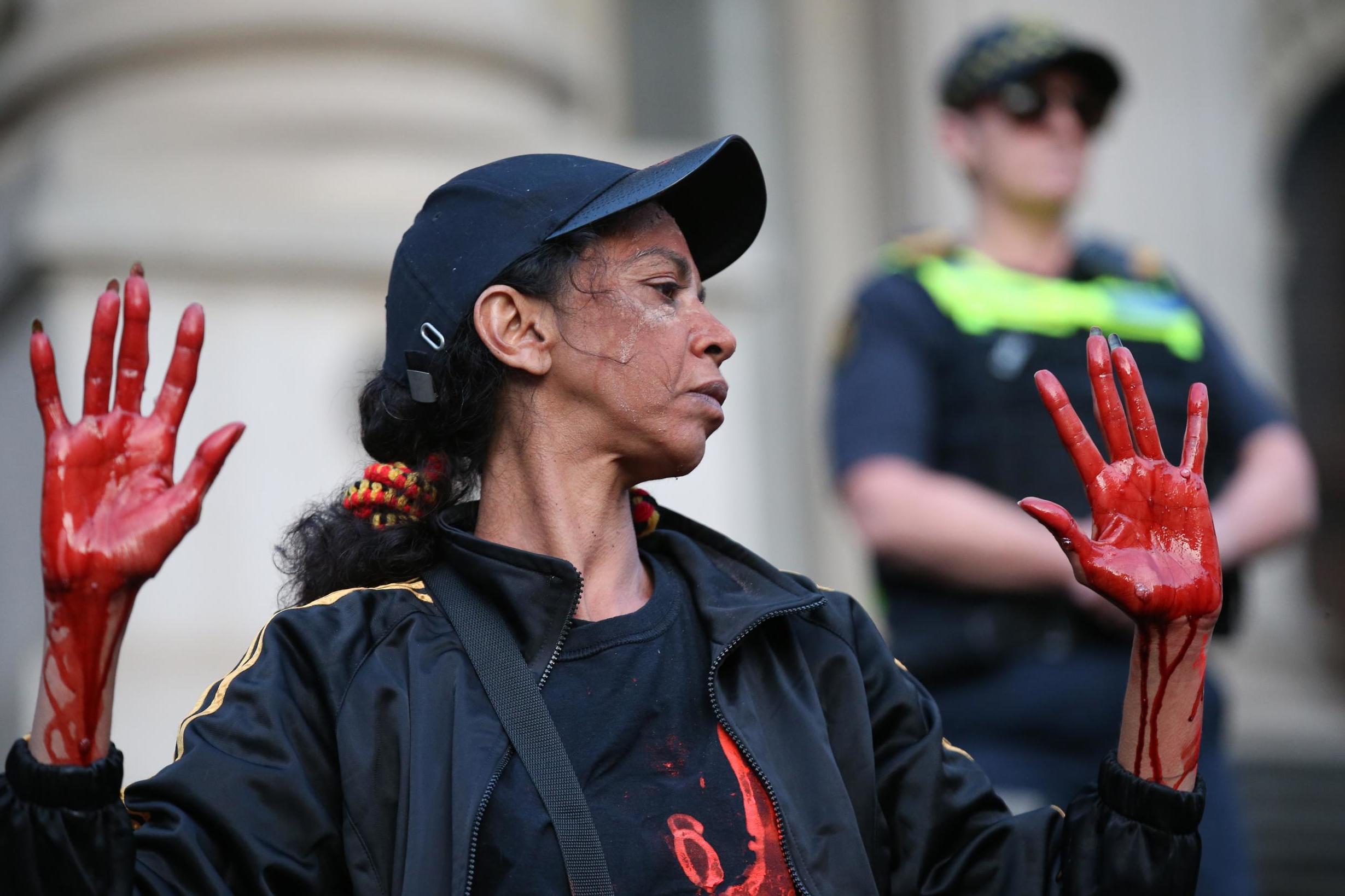 Aboriginal and Torres Strait Islanders communities and allies with their hands painted red march during a protest in Melbourne, Victoria, Australia, 13 November 2019.