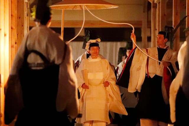 Japan's Emperor Naruhito walks towards one of two main halls of the shrine for Daijosai, or great thanksgiving festival, at the Imperial Palace in Tokyo, Thursday 14 November 2019