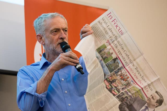 Jeremy Corbyn shows supporters a negative newspaper article on 25 August 2015