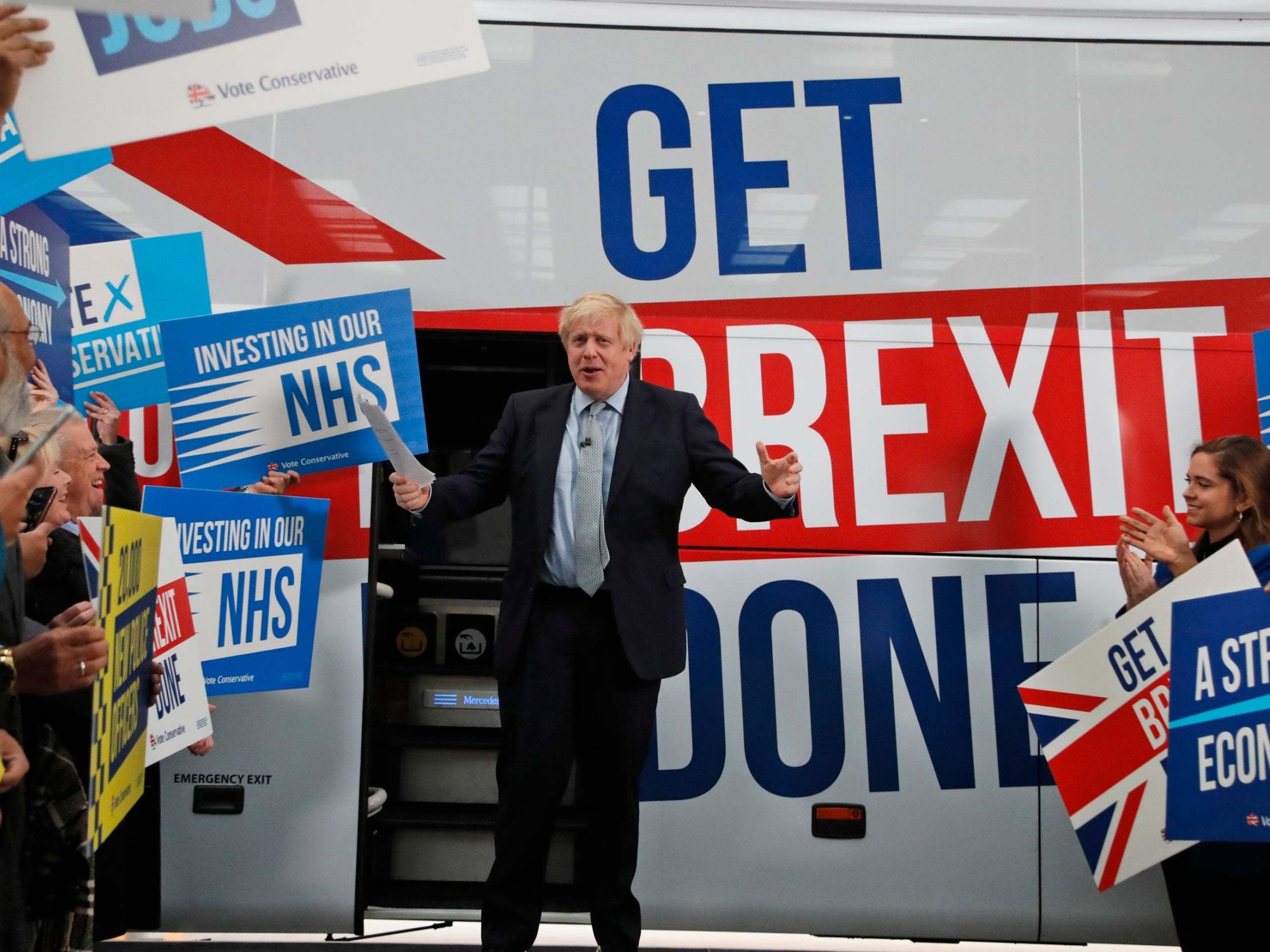 Boris Johnson steps from his battle bus during a campaign trail stop in Middleton, Manchester, on Friday