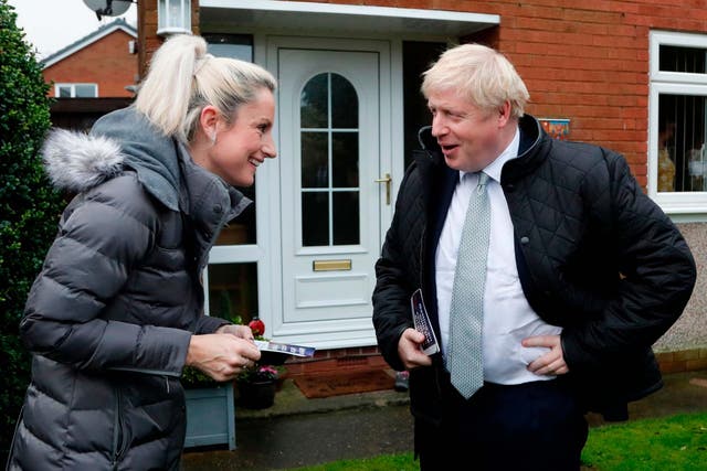 Boris Johnson talks to a voter while canvassing in Mansfield, Nottinghamshire