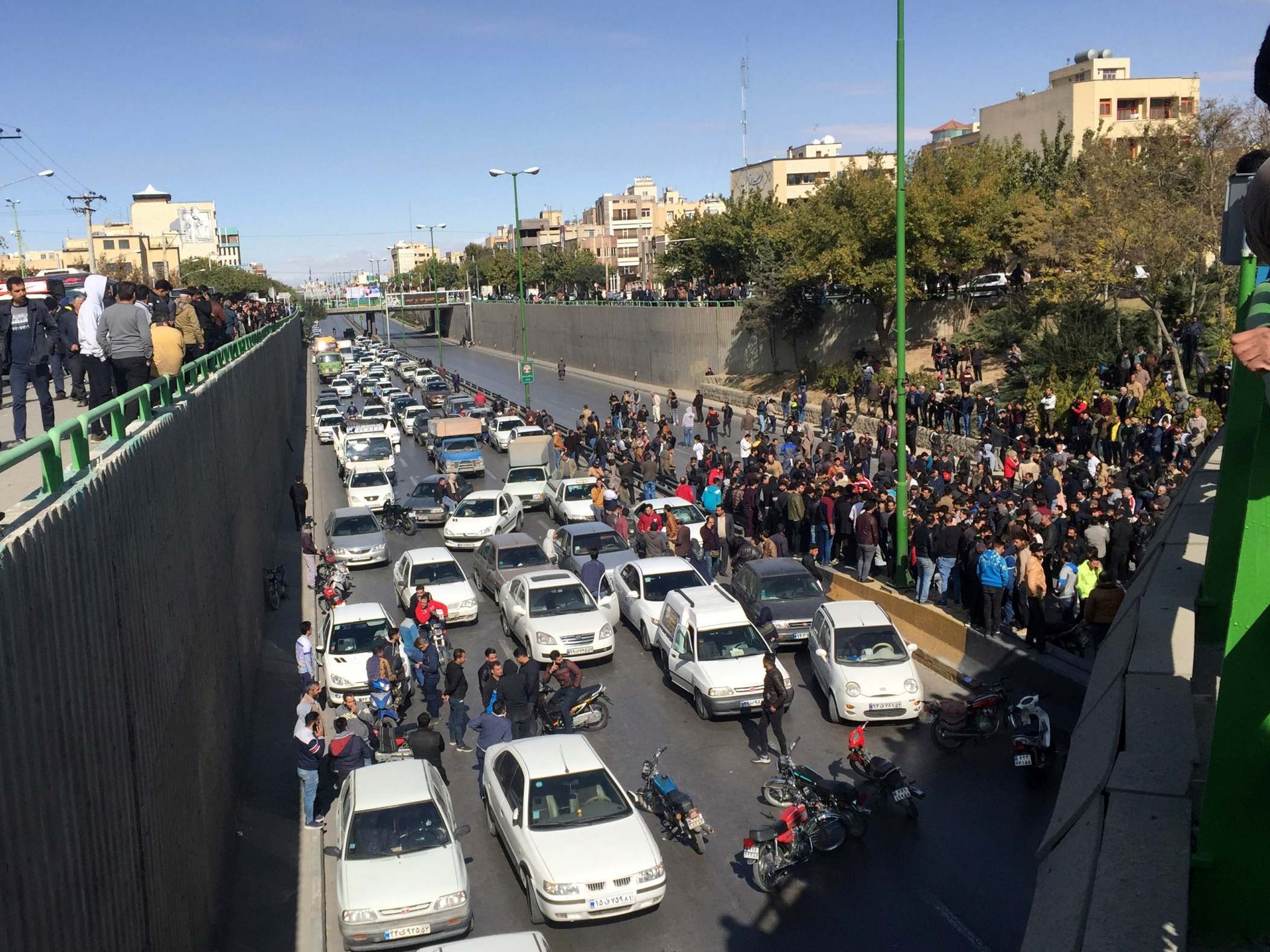 Deadly protests erupt over 50 per cent petrol price increase in Iran as police clash with demonstrators