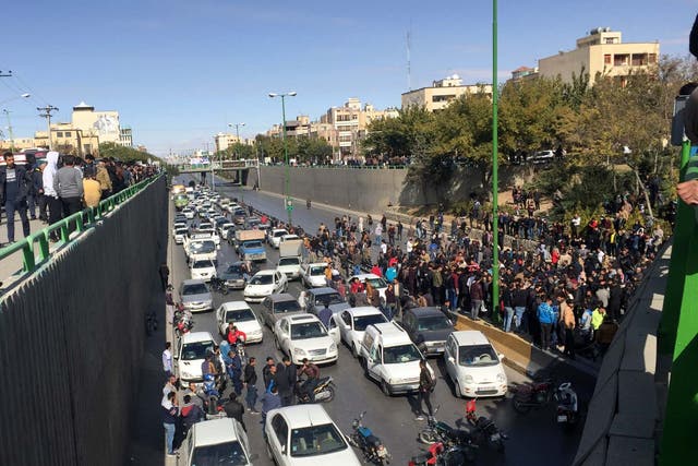 Cars block a street during a protest against a rise in gasoline prices, in the central city of Isfahan, Iran