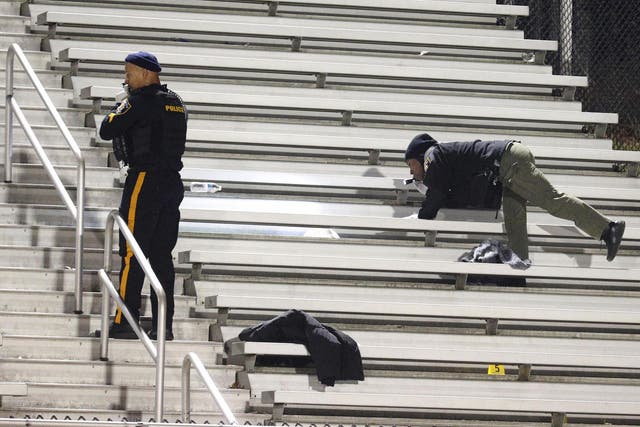 Police officers search the stands after shooter opened fire on fans