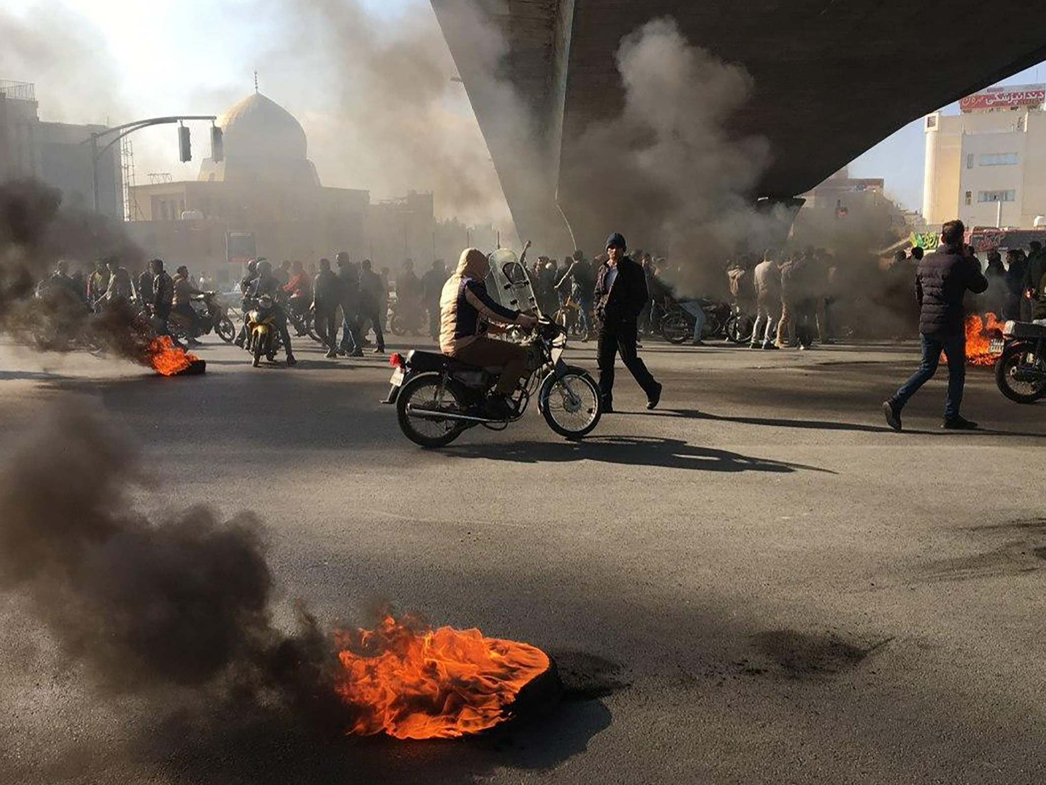 Iranian protesters rally amid burning tires during a demonstration in the central city of Isfahan on November 2019