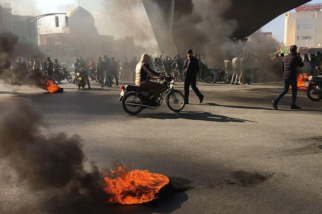 Iranian protesters rally amid burning tires during a demonstration in the central city of Isfahan on November 2019