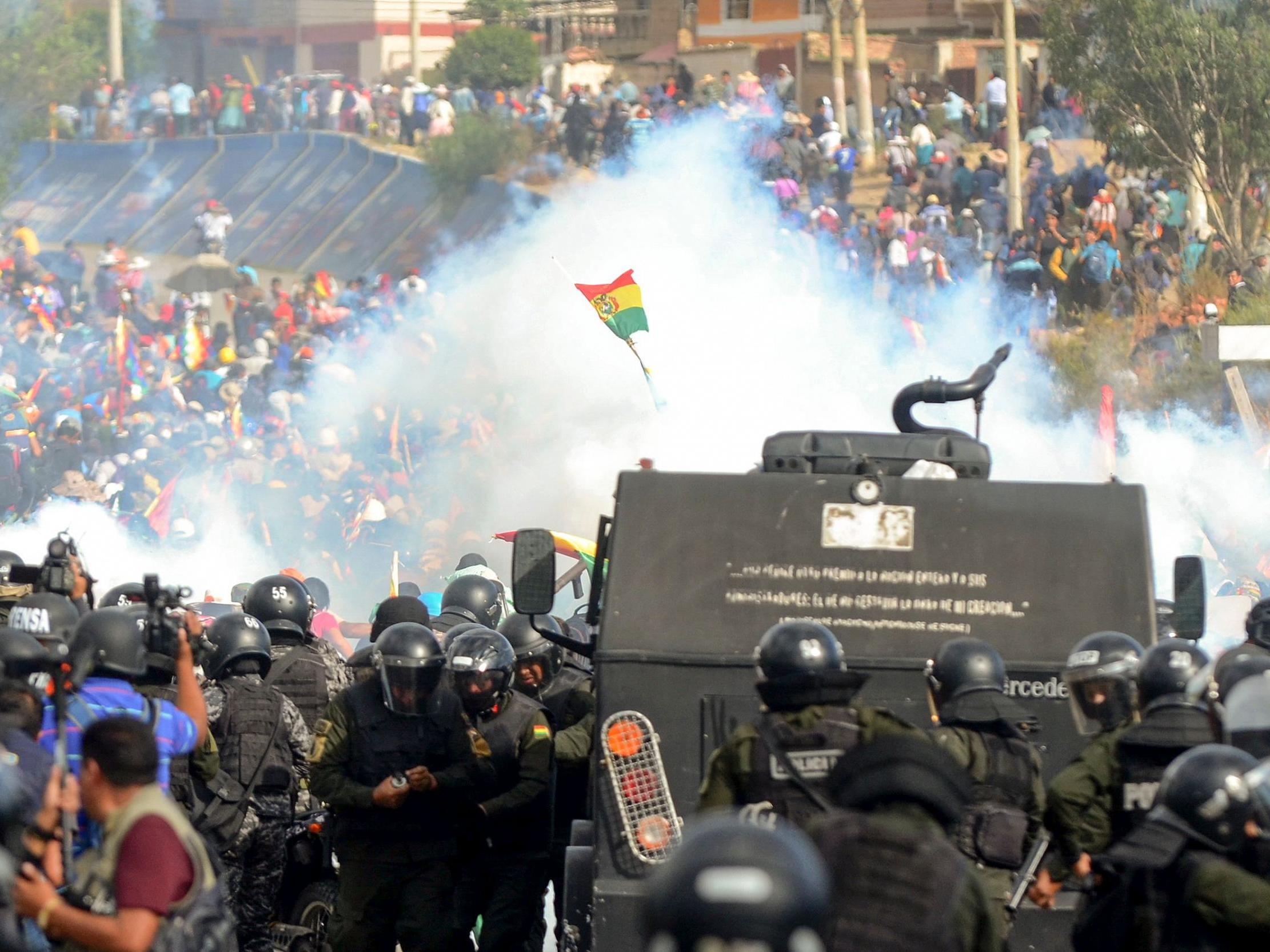 Bolivian riot police clash with supporters of Evo Morales during a protest against the interim government in Sacaba