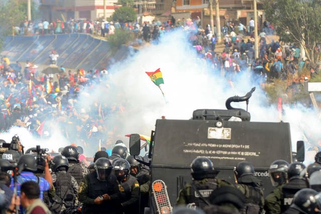  Bolivian riot police clash with supporters of Evo Morales during a protest against the interim government in Sacaba