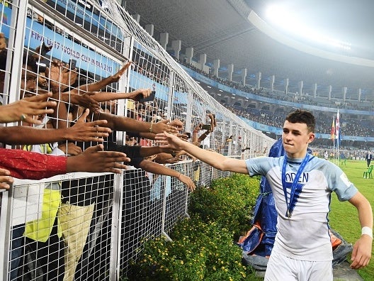 Phil Foden celebrates with supporters in Kolkata, India