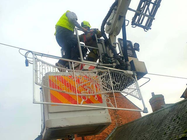 A man is rescued from a broken cherry picker in Market Harborough, Leicestershire