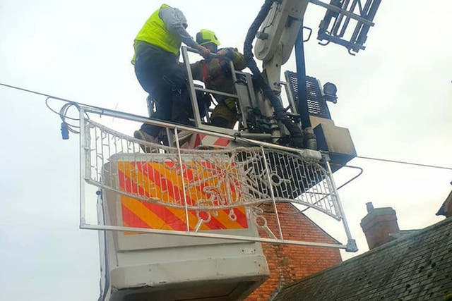 A man is rescued from a broken cherry picker in Market Harborough, Leicestershire