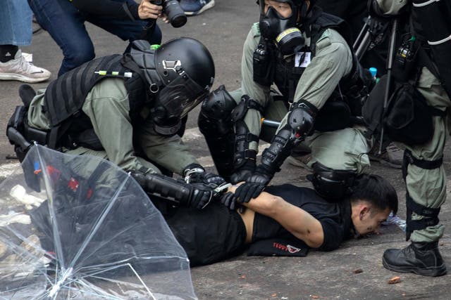 Police detain a protester at the Hong Kong Polytechnic University in Hong Kong