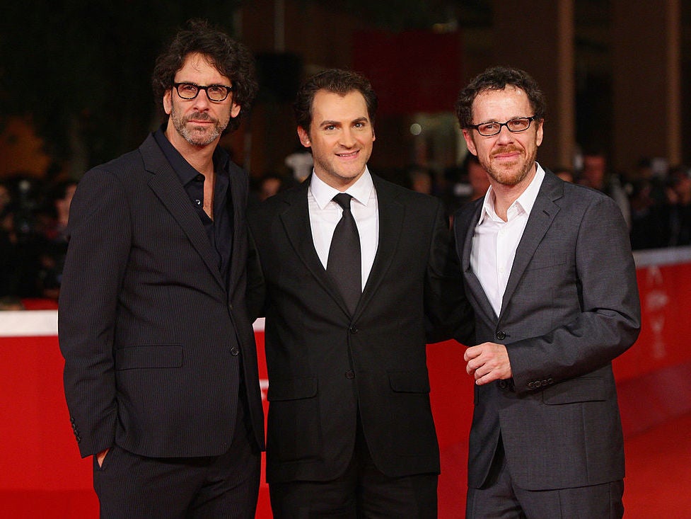 Notoriously noncommittal: Joel and Ethan Coen, on either side of star Stuhlbarg, at the 2009 Rome Film Festival (Getty)