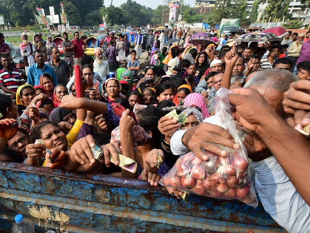 People attempt to buy subsidised onions in Dhaka over the weekend