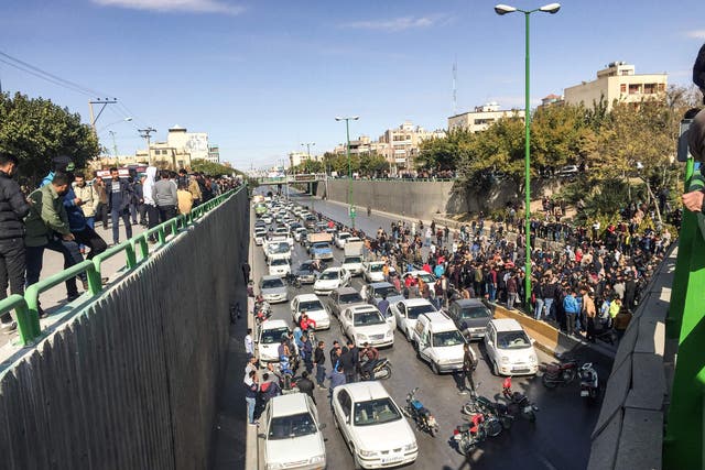 Iranian protesters block a road during protests in the central city of Isfahan on Saturday