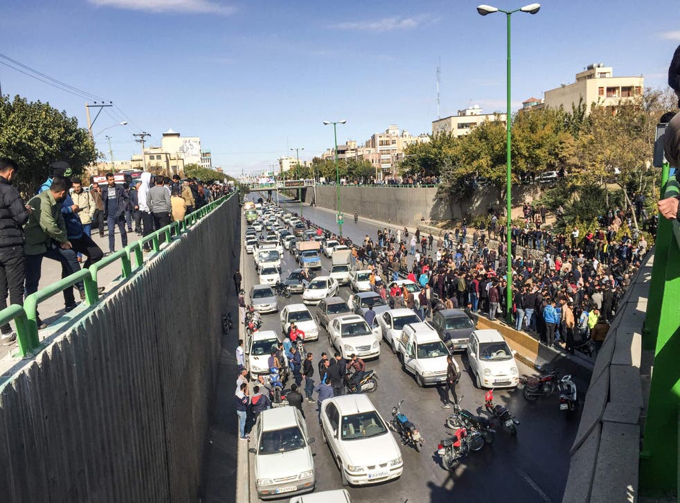 Iranian protesters block a road during protests in the central city of Isfahan on Saturday
