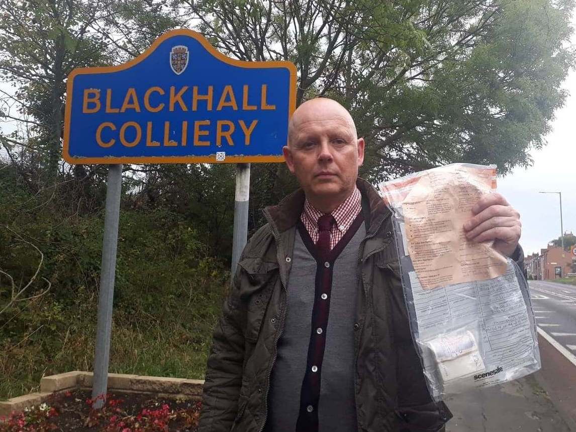 Detective Constable John Forster, of Durham Constabulary, holding one of 13 bundles of £2,000 left around Blackhall Colliery in County Durham by two Good Samaritans between 2014 and 2019.