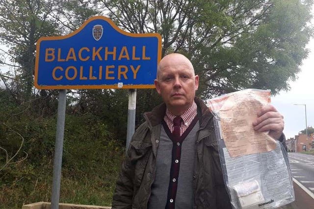 Detective Constable John Forster, of Durham Constabulary, holding one of 13 bundles of £2,000 left around Blackhall Colliery in County Durham by two Good Samaritans between 2014 and 2019.