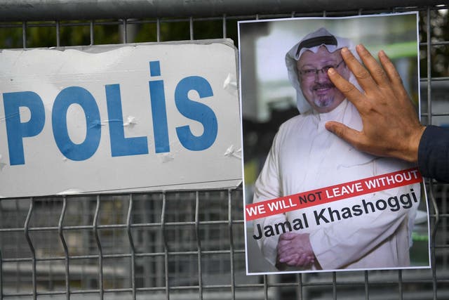 A protester holds a picture of Khashoggi outside the Saudi consulate in Istanbul after the news broke in October 2018