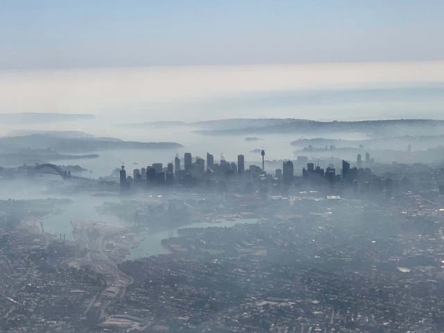 An image taken from a plane window shows Sydney shrouded in smoke