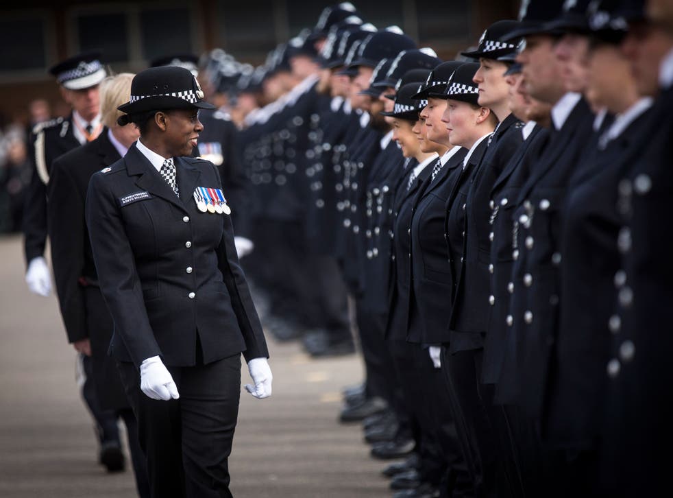 New recruits to the Metropolitan Police Service are inspected by Superintendent Robyn Williams during their passing out parade at Hendon Training Centre on 13 March 2015 in London