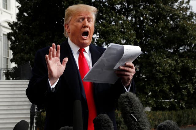 Donald Trump reads from a statement outside the White House in reaction to the impeachment evidence of Gordon Sondland