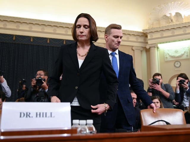 Fiona Hill and David Holmes take their seats ahead of the impeachment hearing