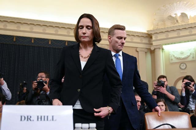 Fiona Hill and David Holmes take their seats ahead of the impeachment hearing