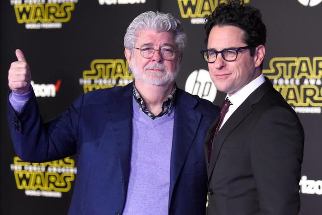 George Lucas and writer-director JJ Abrams attend the premiere of Star Wars: The Force Awakens on 14 December, 2015 in Hollywood, California.