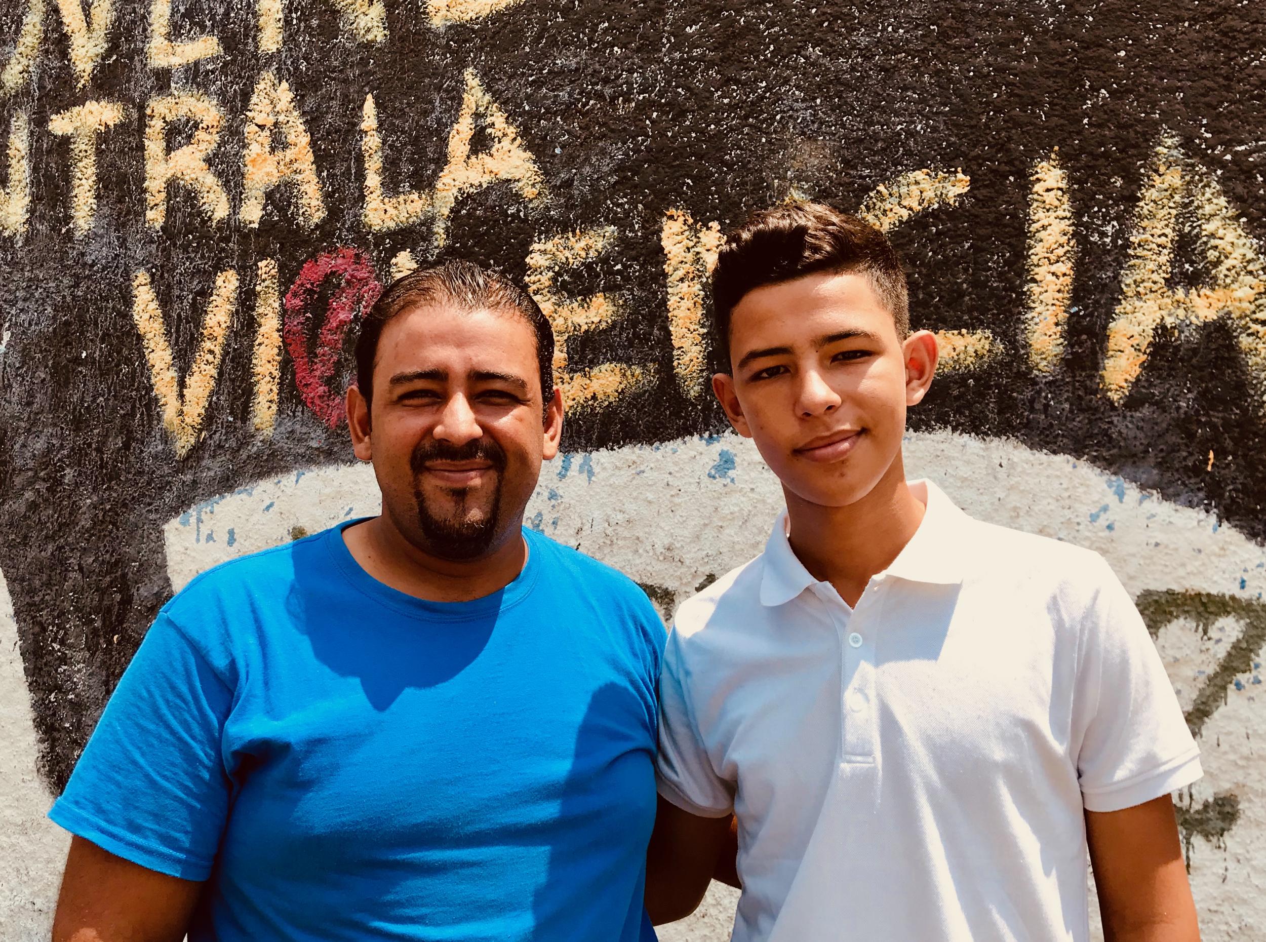 David Fernandez, pictured here with his teenage son and namesake, feeds local children at his church