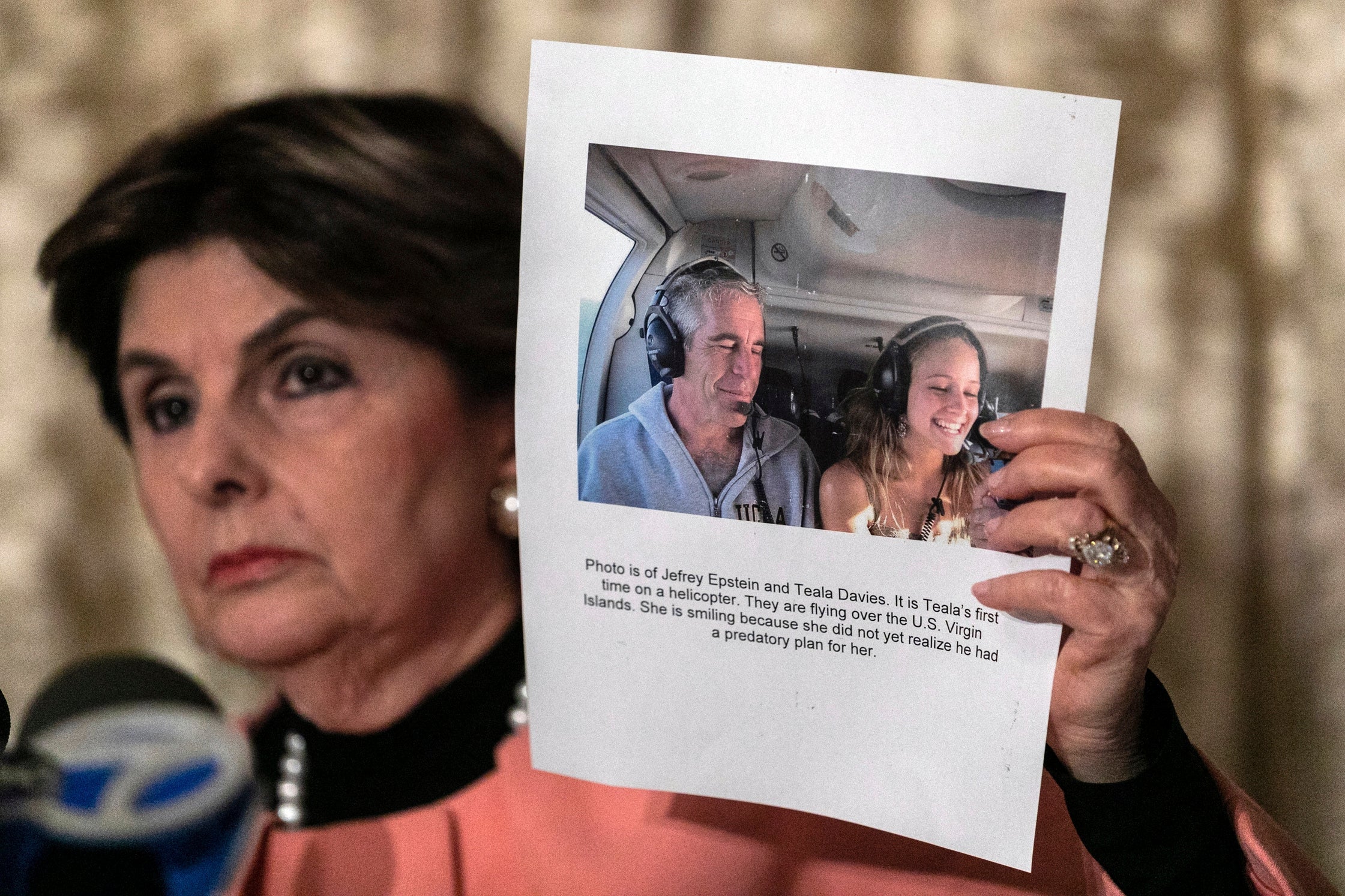 Gloria Allred shows a press conference a photo of Jeffrey Epstein and her client Teala Davies