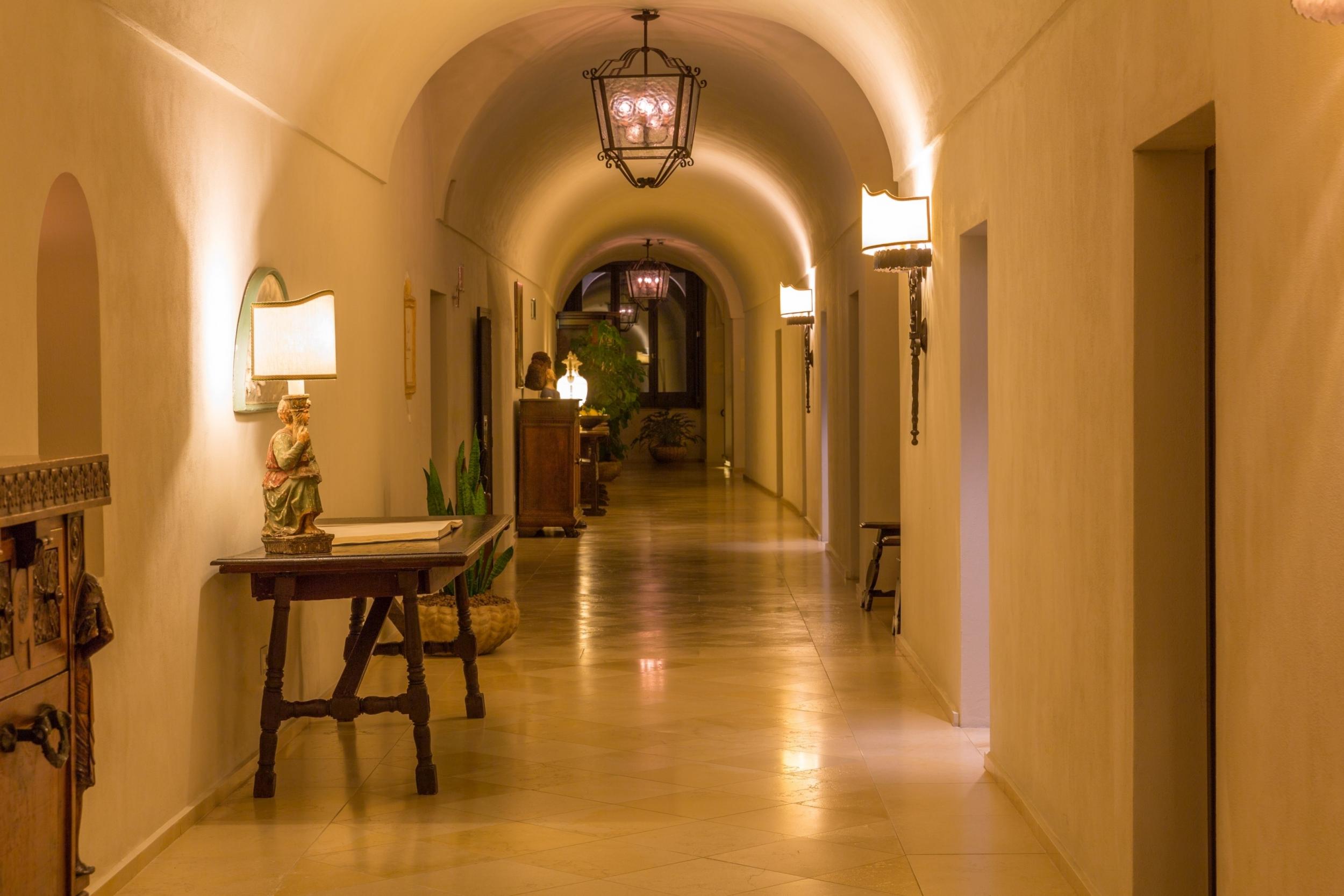 Gently lit stone corridors add to the spiritual feel at Monastero Santa Rosa