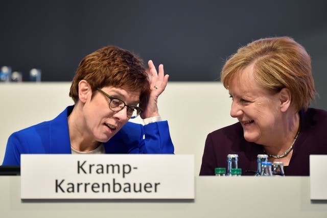 Angela Merkel talks to party chairwoman Annegret Kramp-Karrenbauer during the Christian Democratic Union (CDU) party congress in Leipzig
