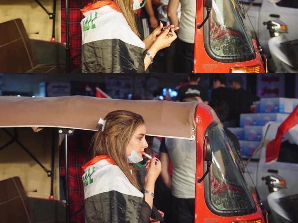 Picture of Refal al-Aziz putting on red lipstick in the mirror of a tuk-tuk vehicle