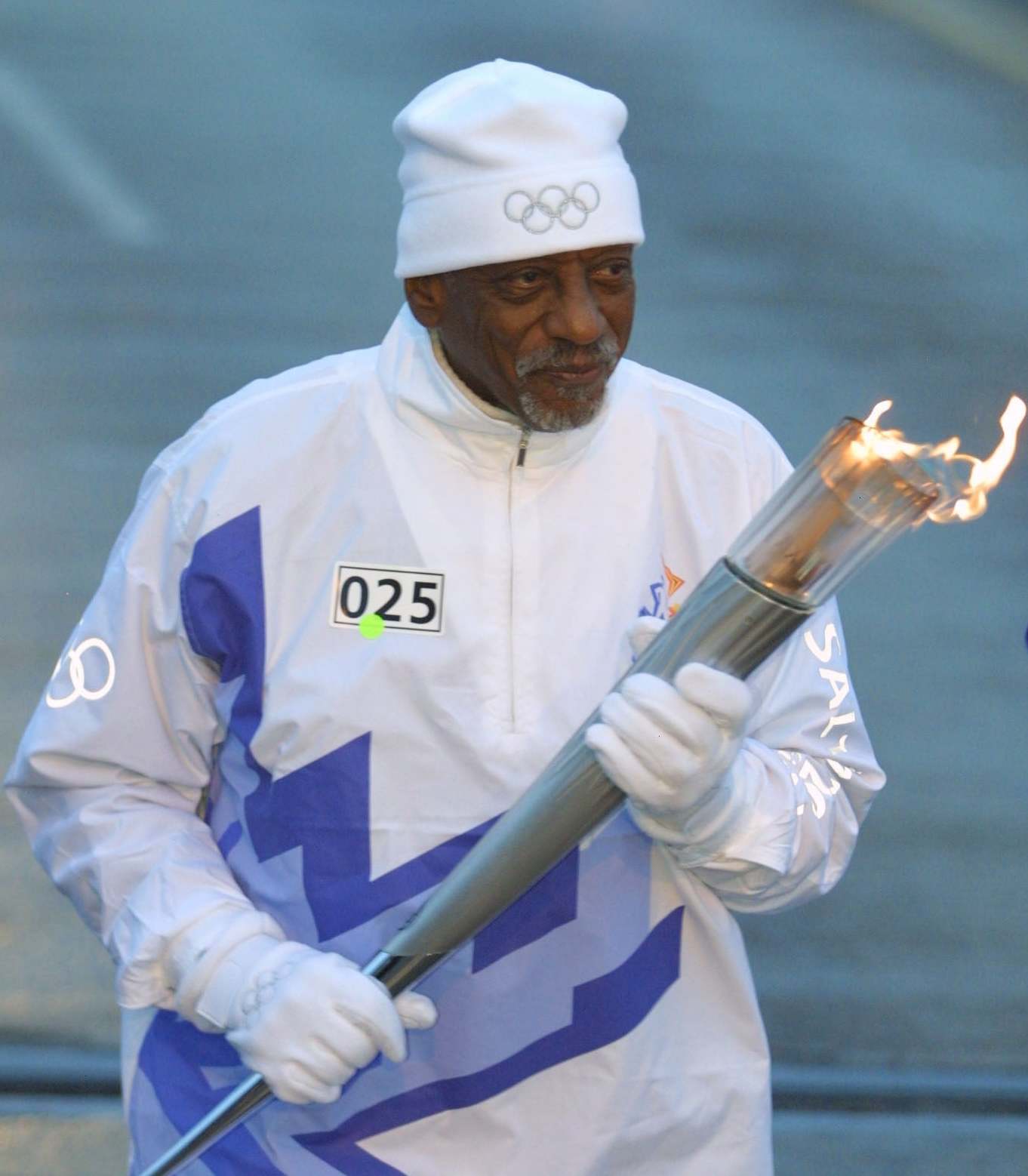 Dillard carries the Olympic flame during the 2002 Salt Lake Olympic Torch Relay in Cleveland, Ohio