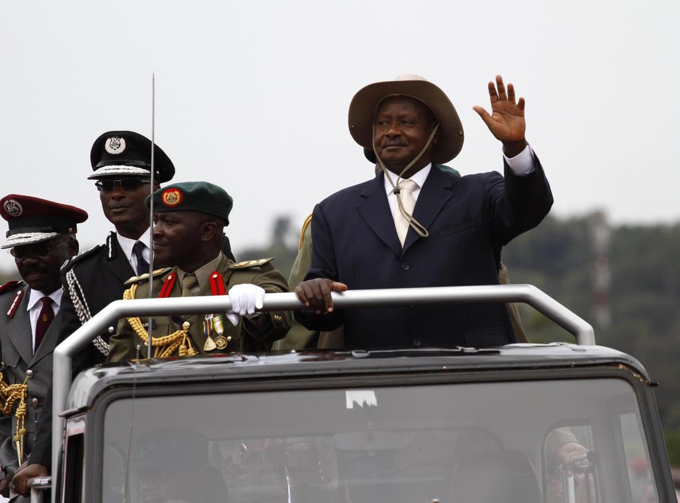Ugandan President Yoweri Museveni waves to supporters during the celebration of the 48th independence day celebration at the Kololo airstrip in Kampala, Ugand