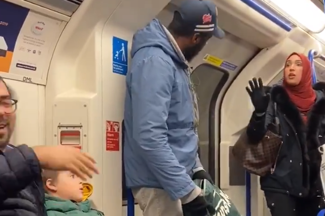 A woman in a headscarf argues with the man who racially abused the Jewish father and children