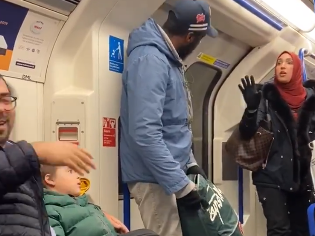 A woman in a headscarf argues with the man who racially abused the Jewish father and children