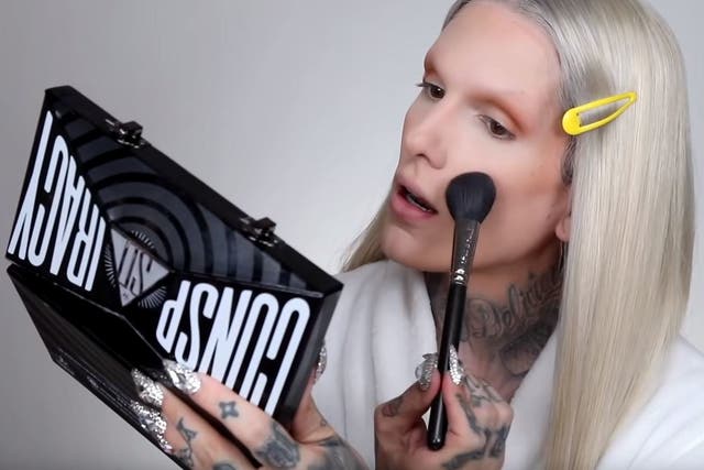 Jeffree Star applies make-up using the Conspiracy eye shadow palette