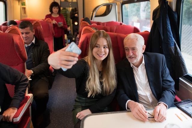 Jeremy Corbyn, with a supporter on train from Sheffield on Saturday, said he will remain neutral in an EU referendum