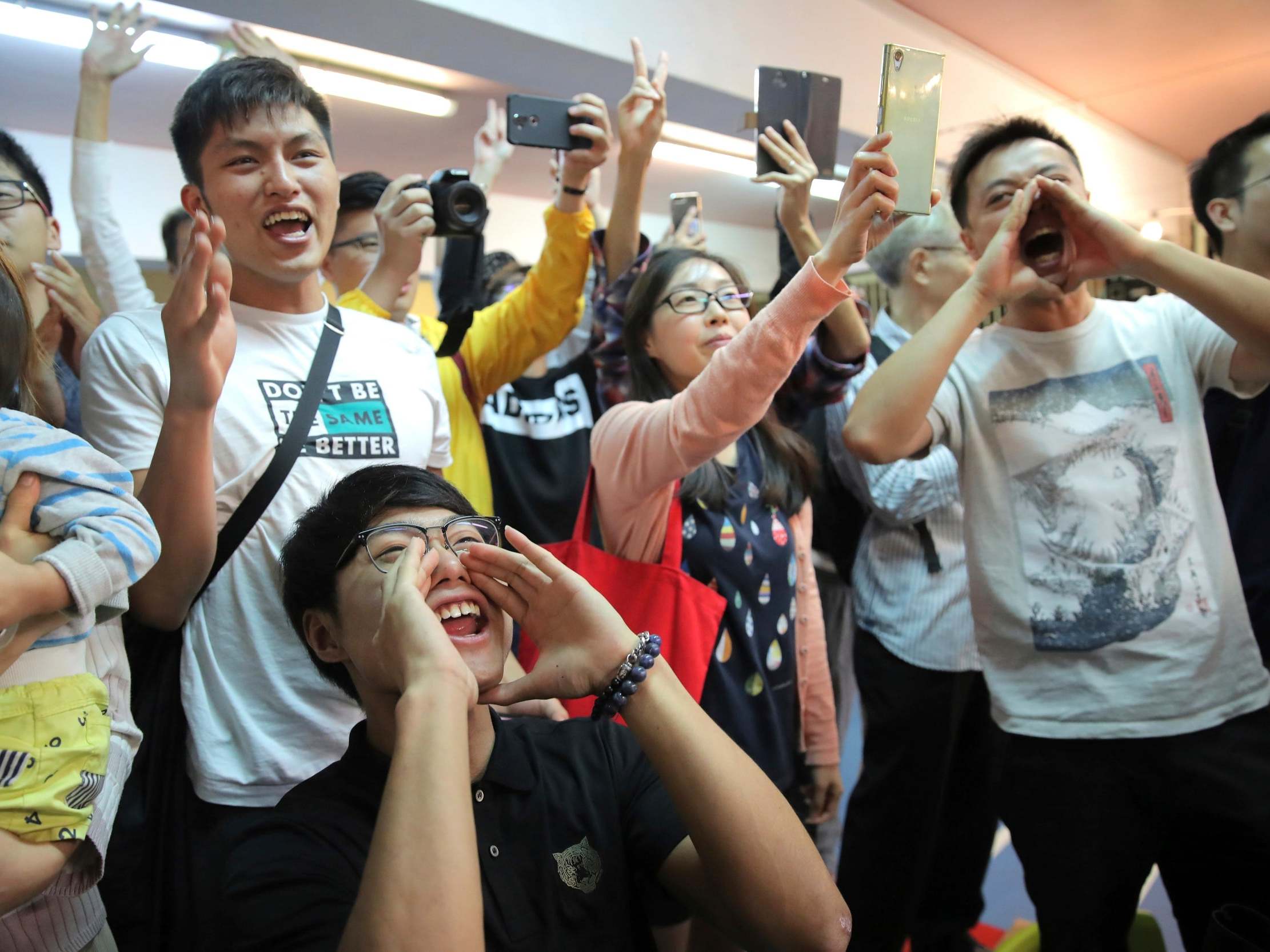 Voters celebrate after hated pro-Beijing politician Junius Ho loses in the Hong Kong district council election