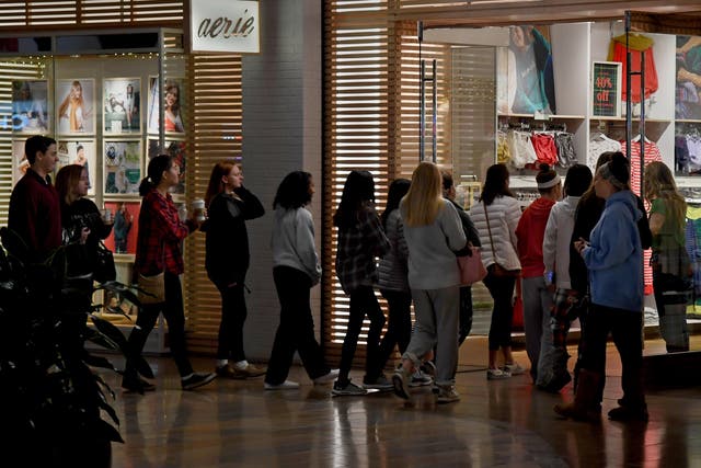 Shoppers line up at the door of the aerie store in Columbia Mall in the Washington suburb of Columbia, Maryland, just as it opened at 6am on Black Friday 2018