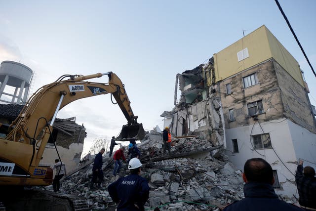 Emergency personnel work near a damaged building in Thumane, after an earthquake shook Albania