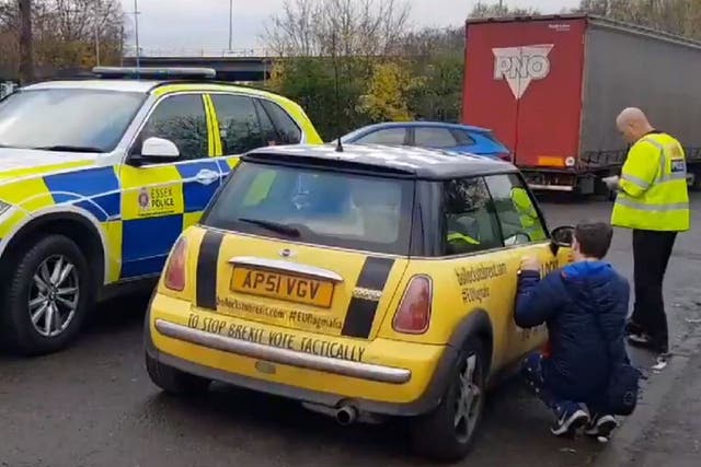 Still image from video posted by B******* to Brexit group showing campaigner removing sticker from car after being pulled over on M25 near Brentwood