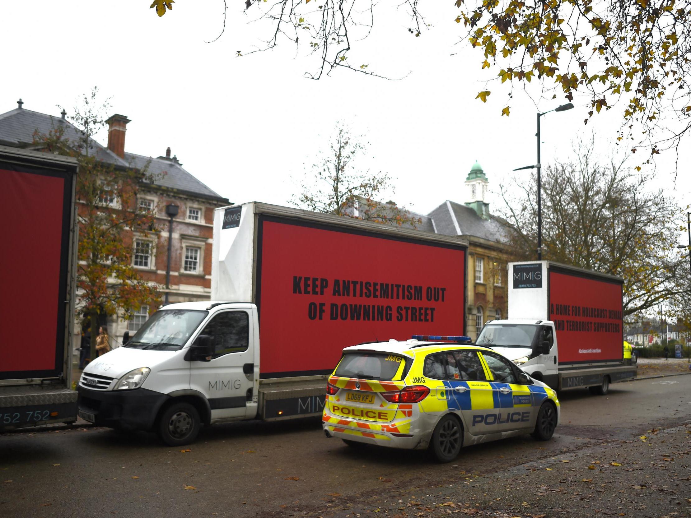 Vans belonging to The Community United against Labour Party anti-Semitism group in London on Tuesday