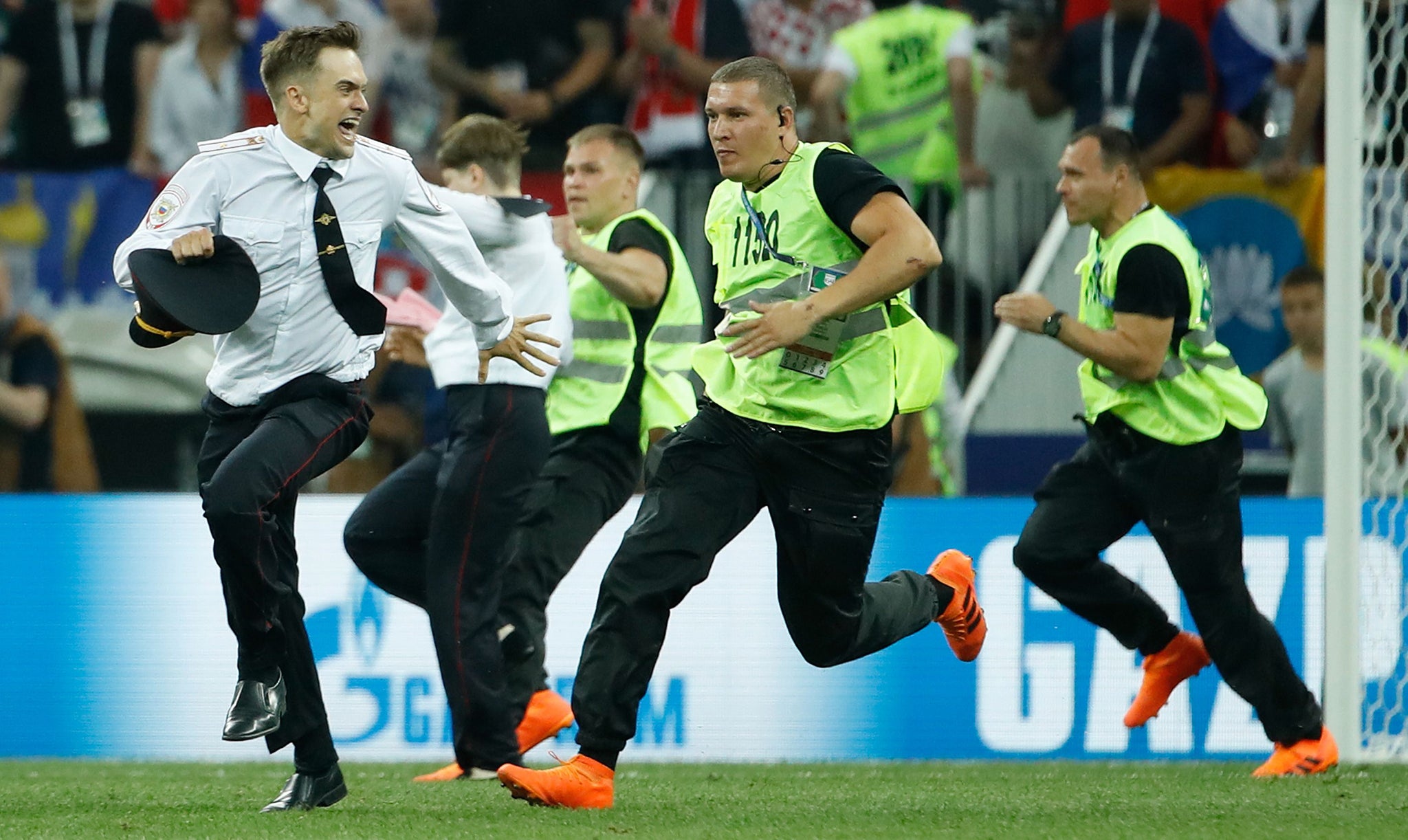 Stewards chase Verzilov after he invaded the pitch during the Russia 2018 World Cup final match between France and Croatia in Moscow