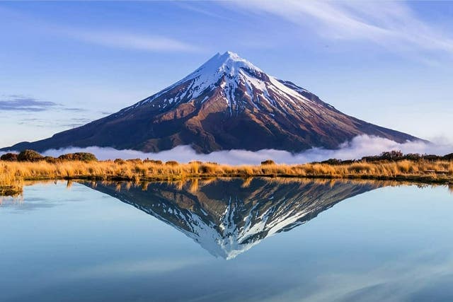 <p>‘Mount Taranaki, New Zealand’ by @superthijs shows Mount Taranaki  in New Zeland reflected in a lake </p>